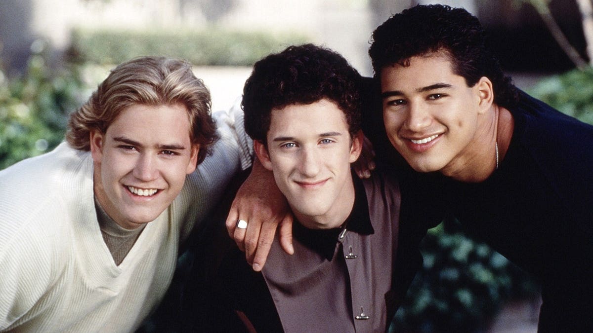 Mark-Paul Gosselaar, Dustin Diamond, and Mario Lopez posing for a promotional photo for Saved by the Bell: The College Years.