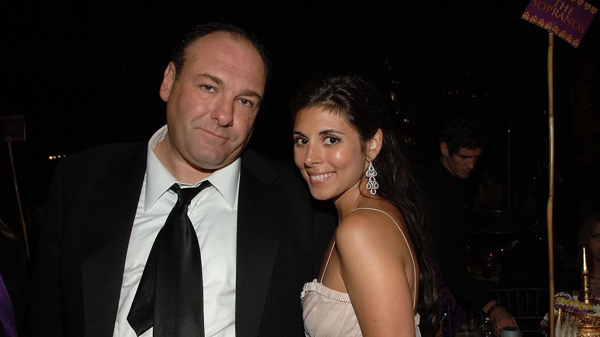 Actors James Gandolfini and Jamie-Lynn Sigler standing together at an event