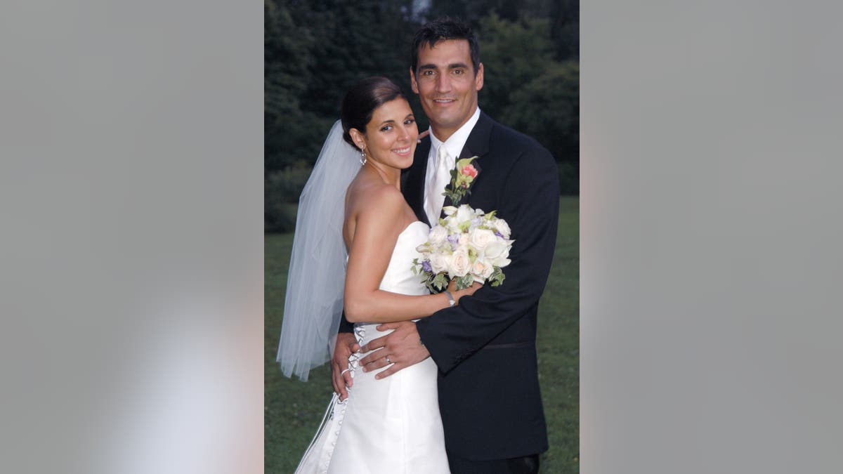 Jamie-Lynn Sigler and AJ DiScala standing together at their wedding reception in New York City