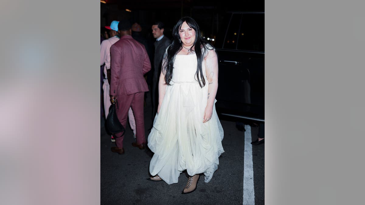 Lena Dunham standing at the GQ Met Gala after party in New York City