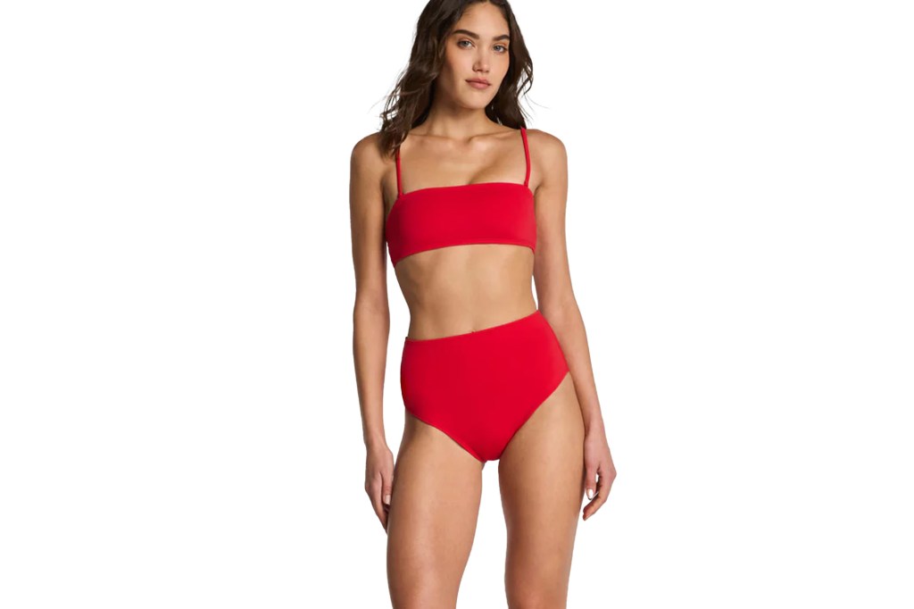 A model wearing a red bandeau bikini top with thin straps and matching high-waisted bikini bottoms.