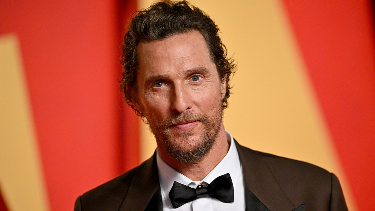 Matthew McConaughey standing and smiling
