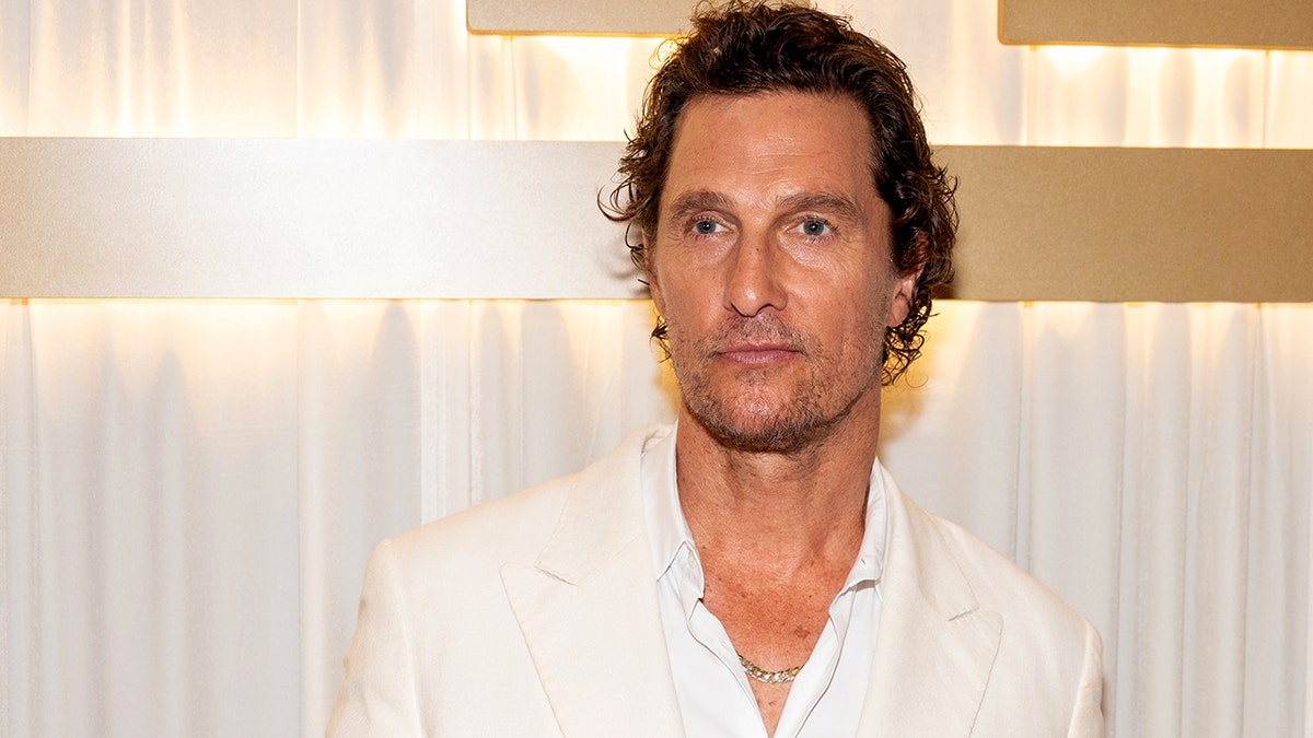 Matthew McConaughey wearing a white shirt at an event venue.