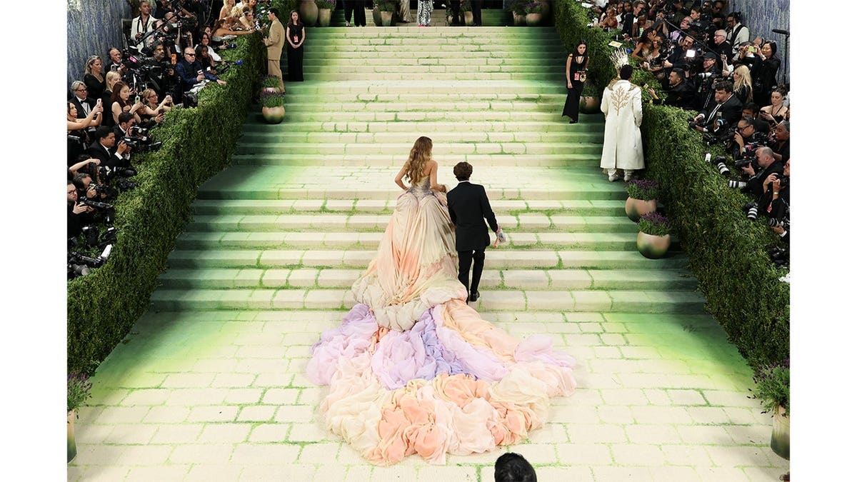 Blake Lively walks up the stairs at the Met Gala