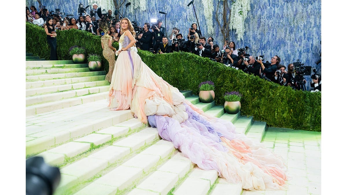 Blake Lively stands sideways on the Met Gala steps