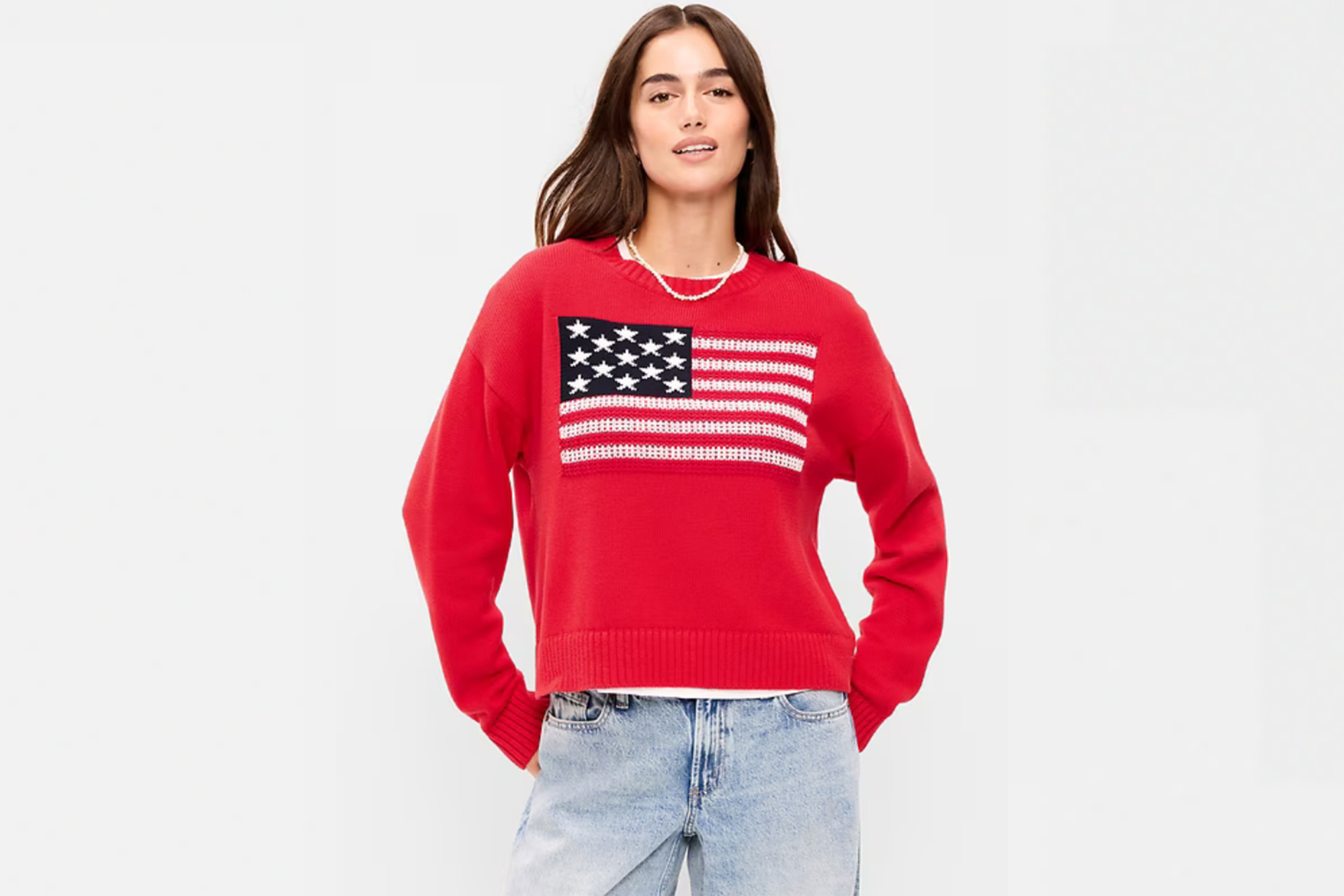 Woman wearing a red sweater with an American flag design.