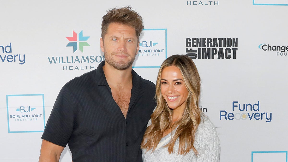 Jana Kramer standing next to husband Allan Russell at a pickleball event