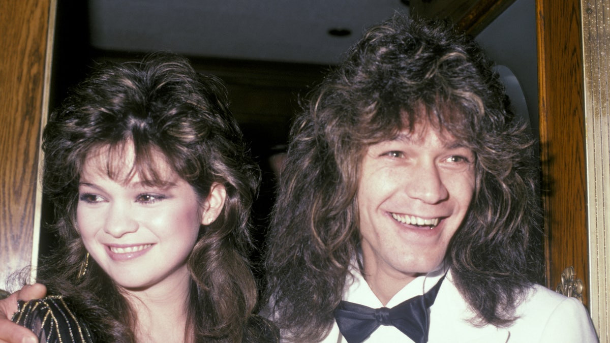 Musician Eddie Van Halen laughing next to wife Valerie Bertinelli at a restaurant