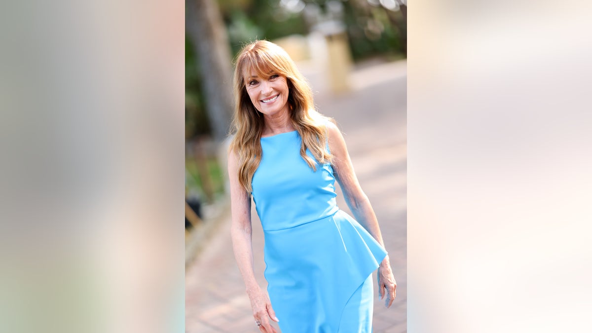 Jane Seymour walking outside wearing a blue sleeveless dress at Filming Italy 2025 photocall