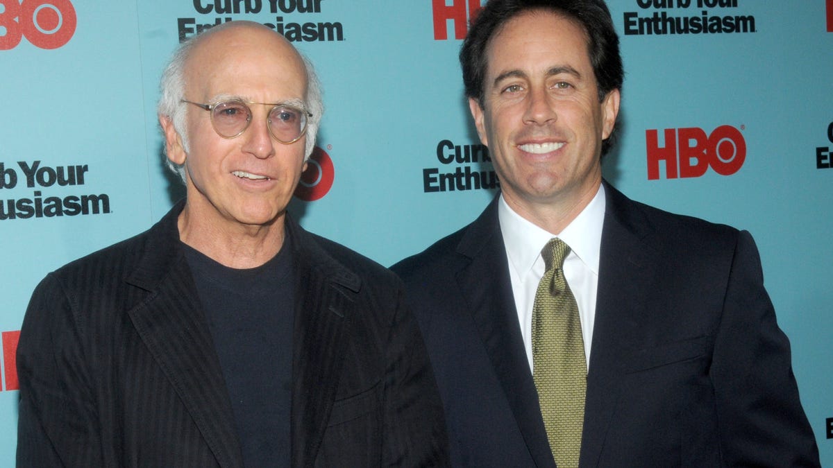 Larry David and Jerry Seinfeld standing together at a screening event in New York City