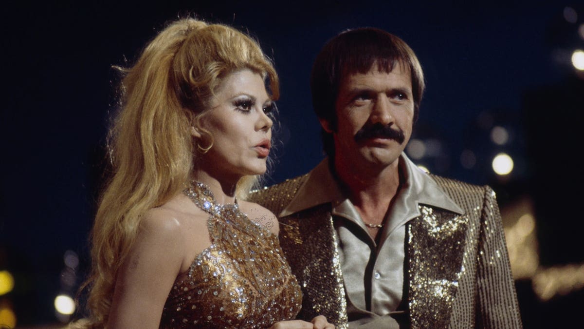 Charo and Sonny Bono standing together on the set of The Sonny Comedy Revue