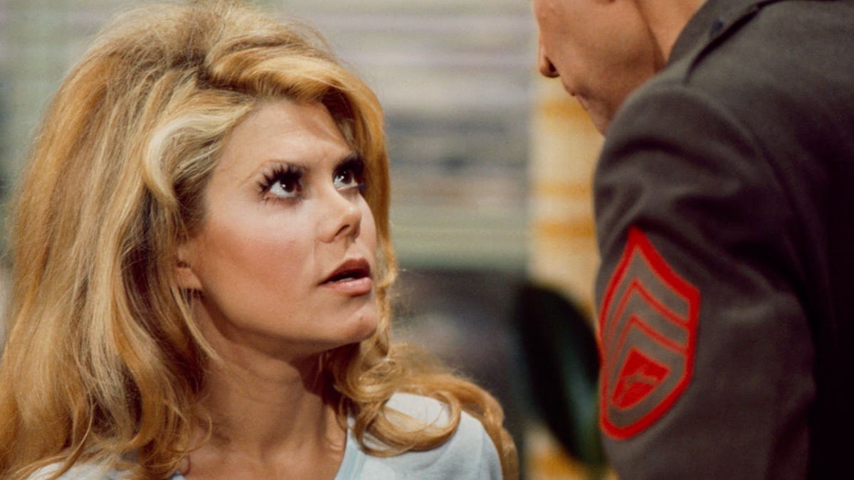 Charo and Tom Lester standing together in a scene from the ABC TV movie 'Charo and the Sergeant'
