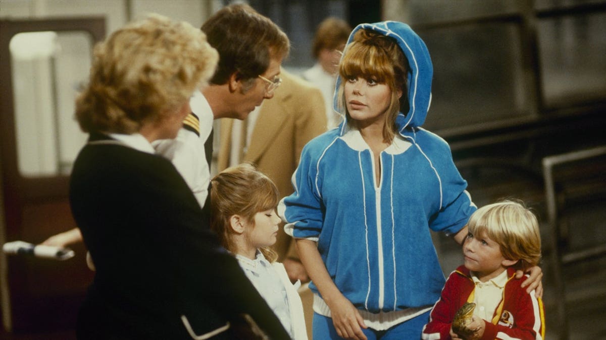 Lauren Tewes, Bernie Kopell, Rachel Jacobs, Charo, and Alex Woodard posing in a scene from Loveboat