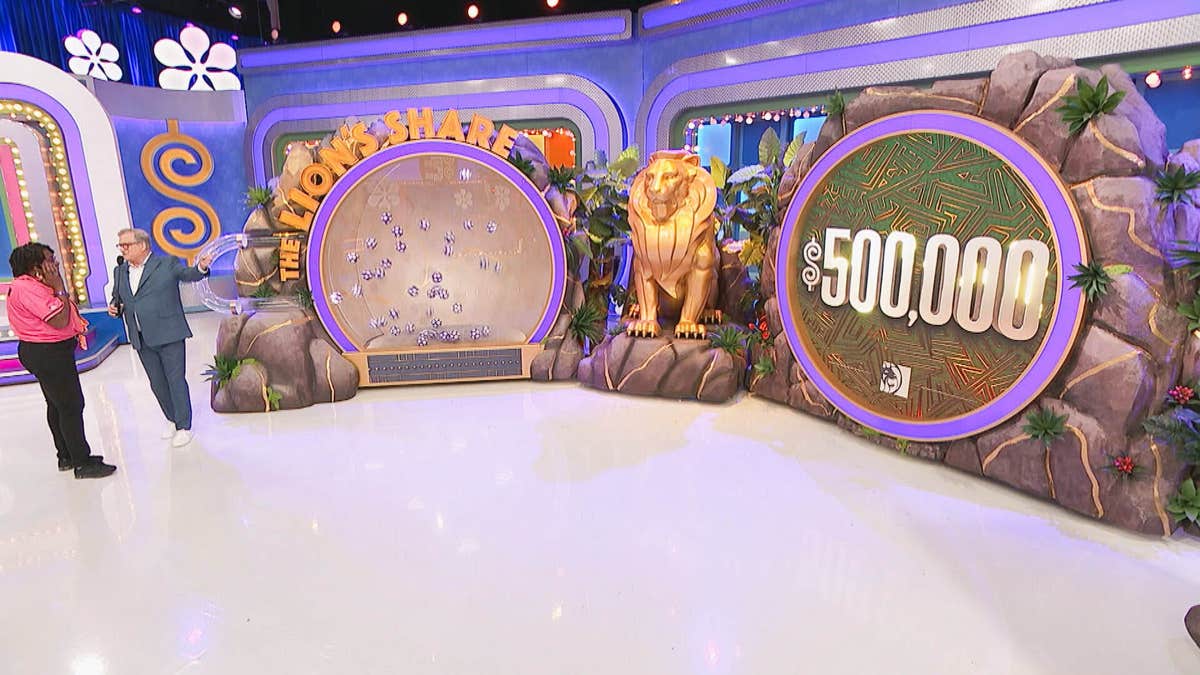 Vanesa and Drew Carey standing on The Price Is Right set