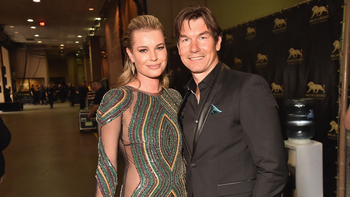 Rebecca Romijn and Jerry O'Connell standing together at an event.