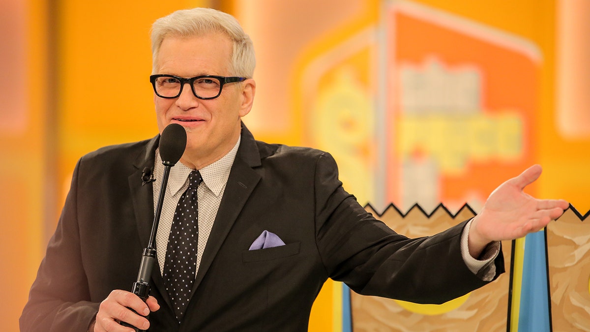 Drew Carey standing on The Price is Right set at CBS Studios in Los Angeles